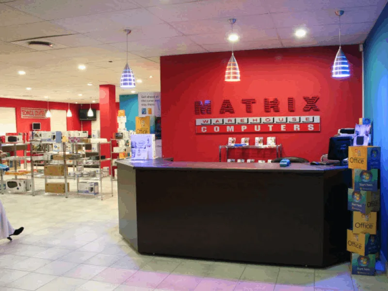 The Matrix Warehouse Computers store in Durbanville, with a red feature wall and service counter